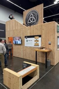 Mass timber fabrication booth showing panel construction and assembly process